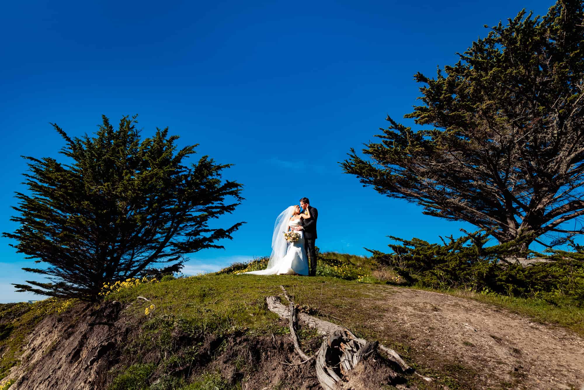 couple shot on a cliff before the wedding outside the Ritz-Carlton Half Moon Bay