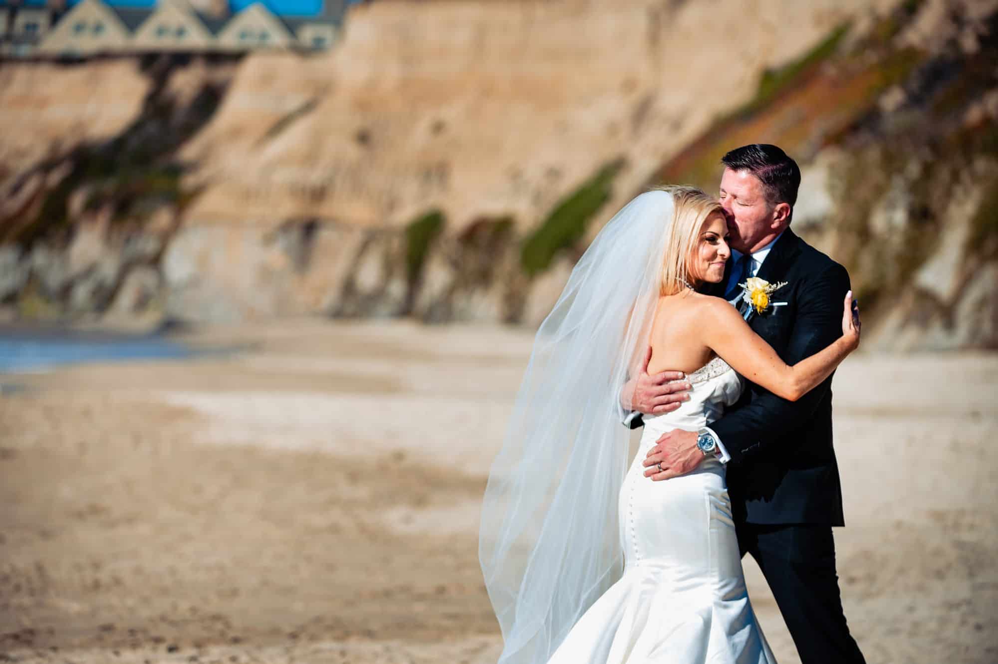 couple walking along the beach before the wedding outside the Ritz-Carlton Half Moon Bay