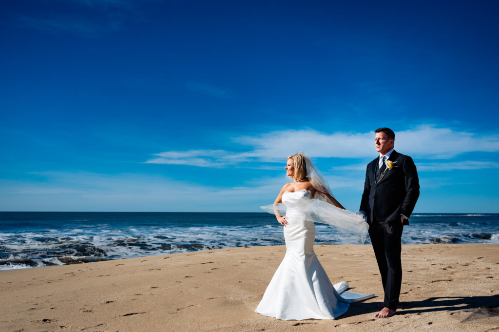 barefoot couple walking along the beach before the wedding outside the Ritz-Carlton Half Moon Bay