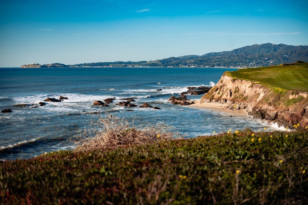 seaside shot of a at a beach wedding ceremony held outside the Ritz-Carlton Half Moon Bay