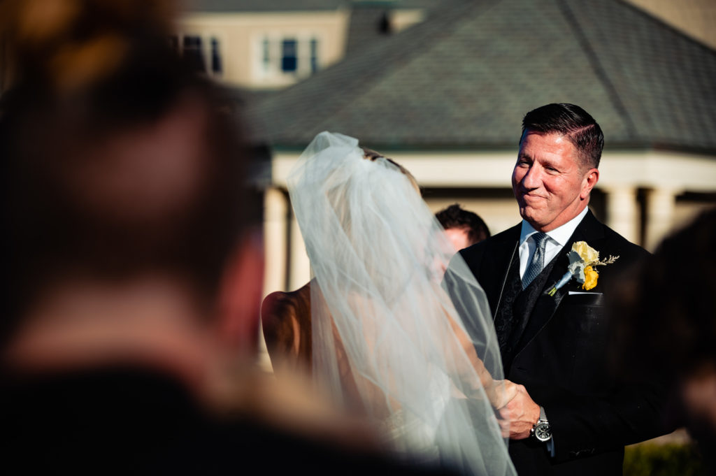 couple smiling at each other during their beach wedding ceremony held outside the Ritz-Carlton Half Moon Bay