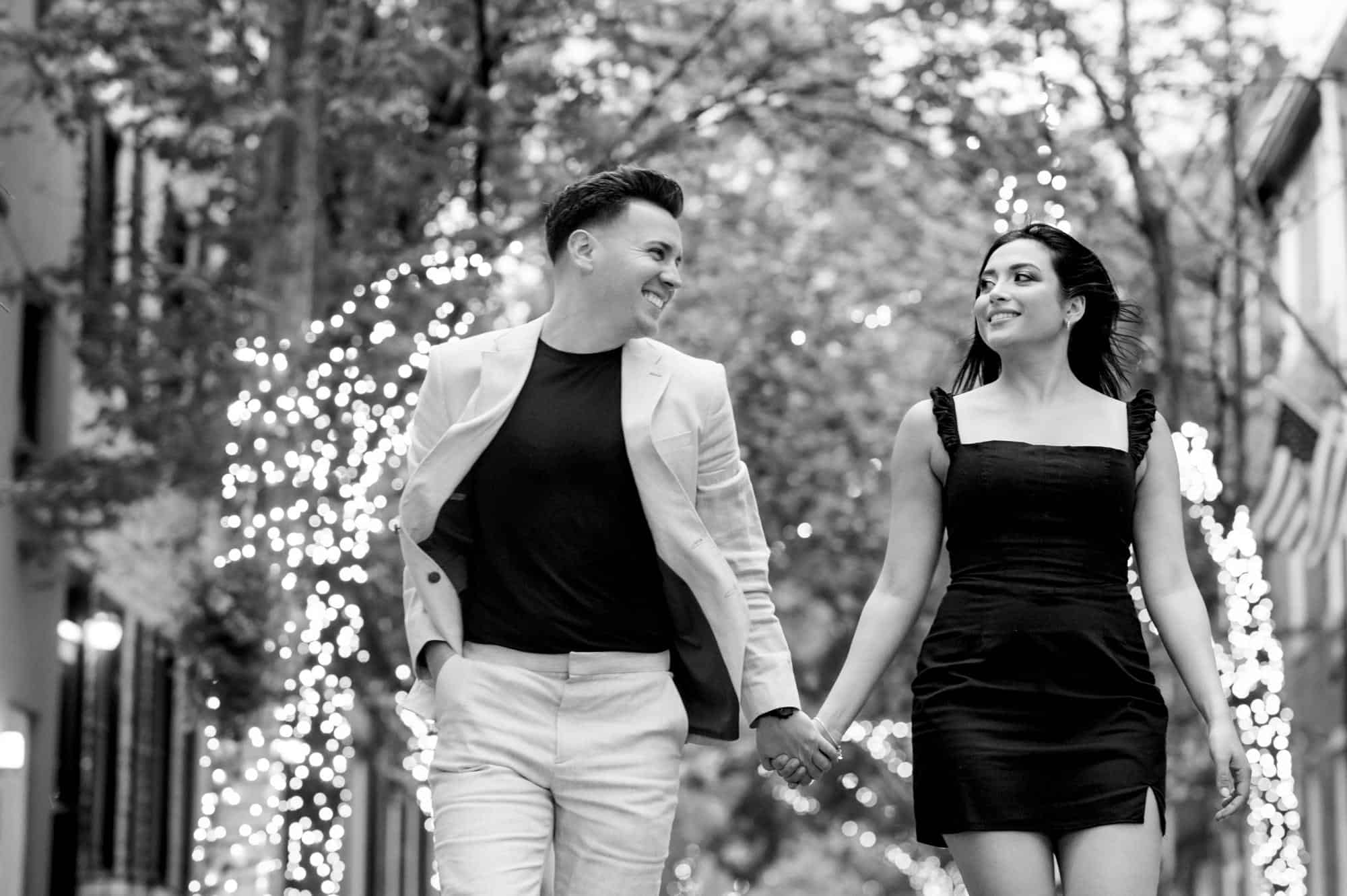 black and white shot of the couple walking in an alley during their center city e-session