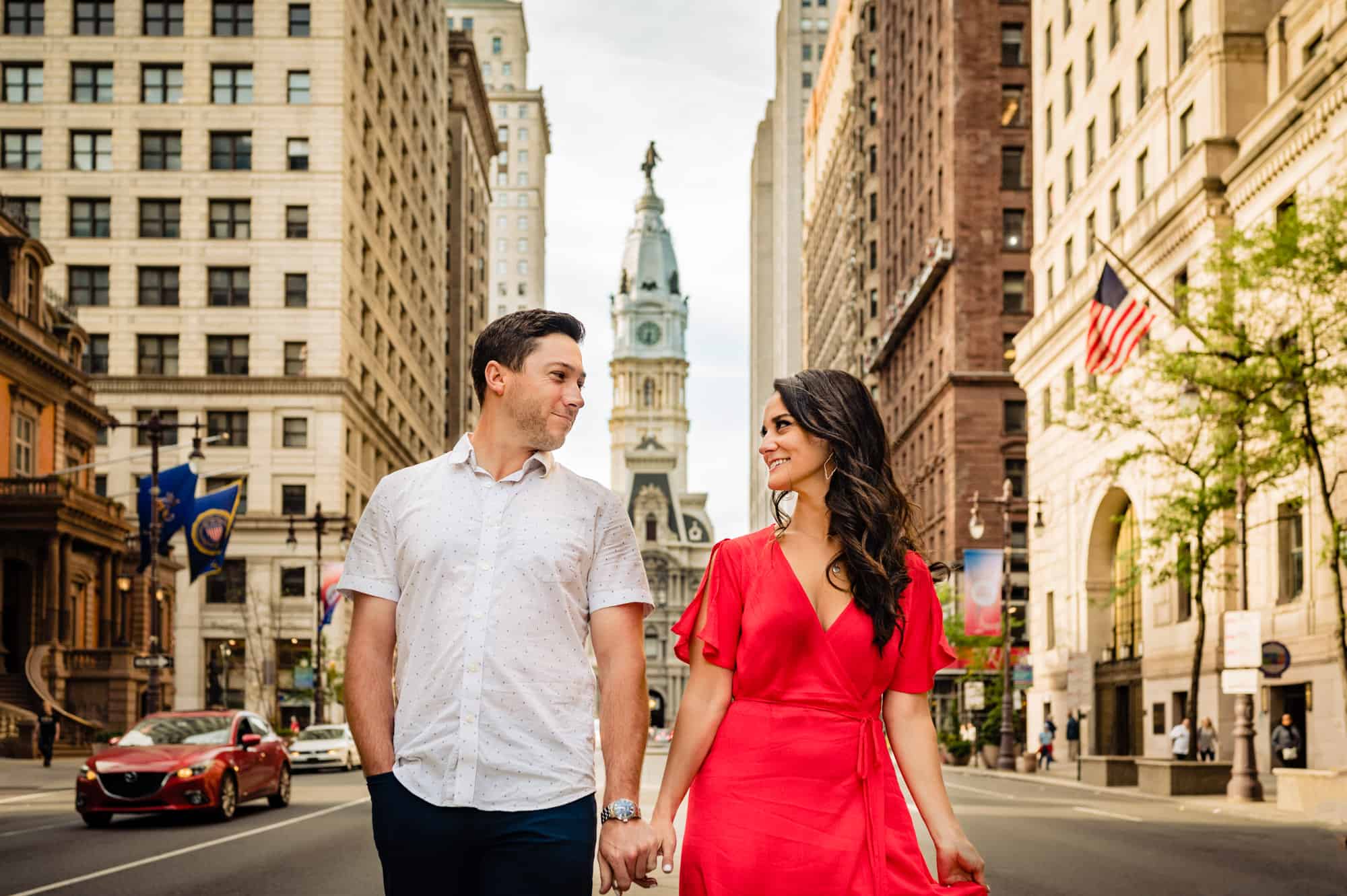 couple taking a pose outside the philly city hall during their philly art museum e-shoot