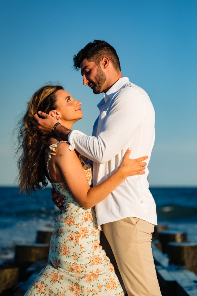 couple smiling at each other during their margate new jersey e-session