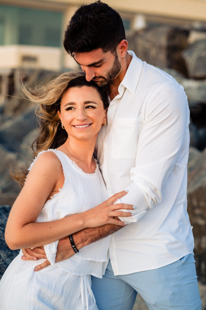 woman smiling while being hugged by her lover
