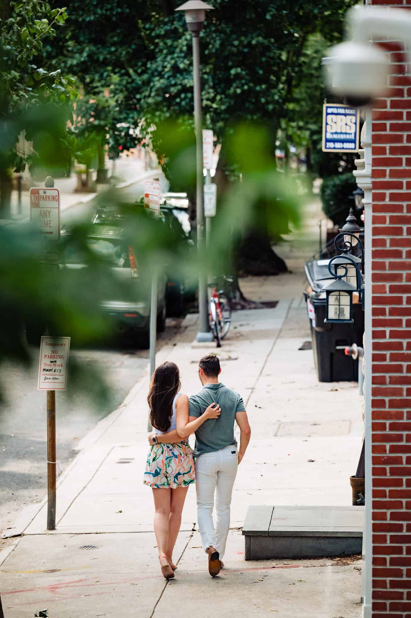 backshot of the couple walking along the stree during their center city e-session