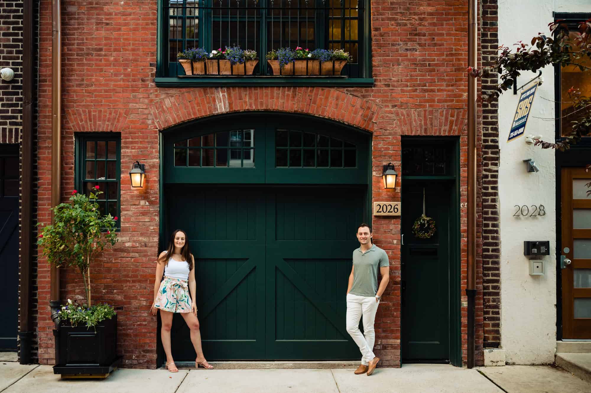 couple poses on the side of the street for their center philly e-session