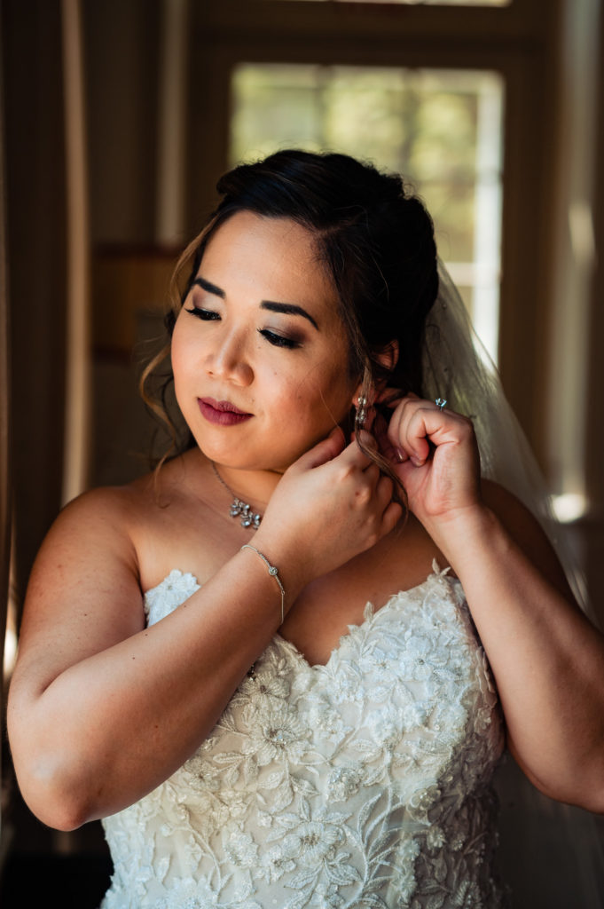 bride is wearing her diamong earrings