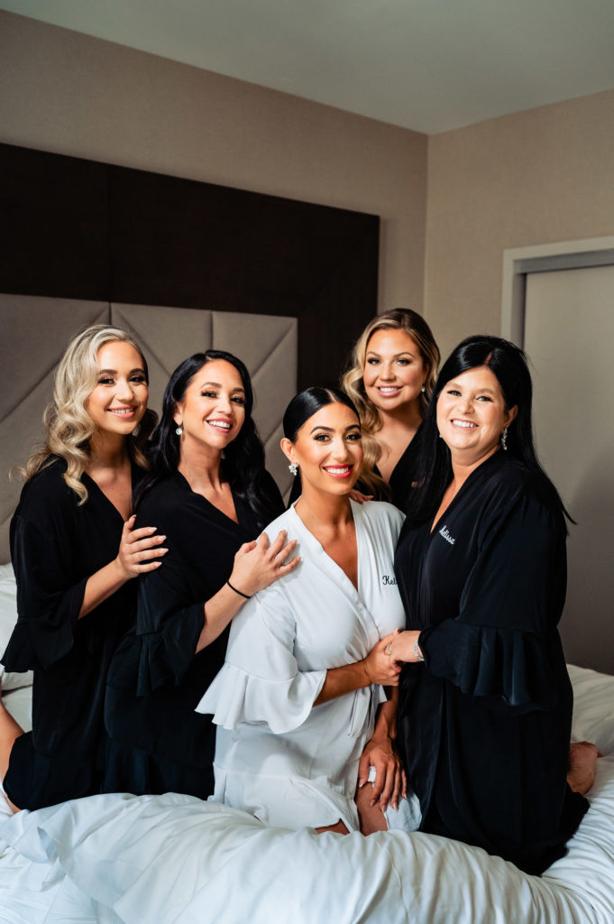 bride and bridesmaids poses in their robes