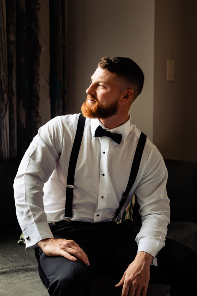 groom poses for the camera