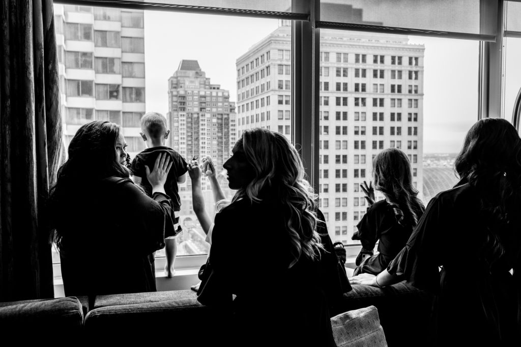 black and white shot of the bridesmaid looking at the view