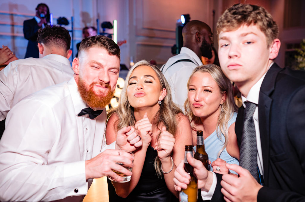 groom posing with guests