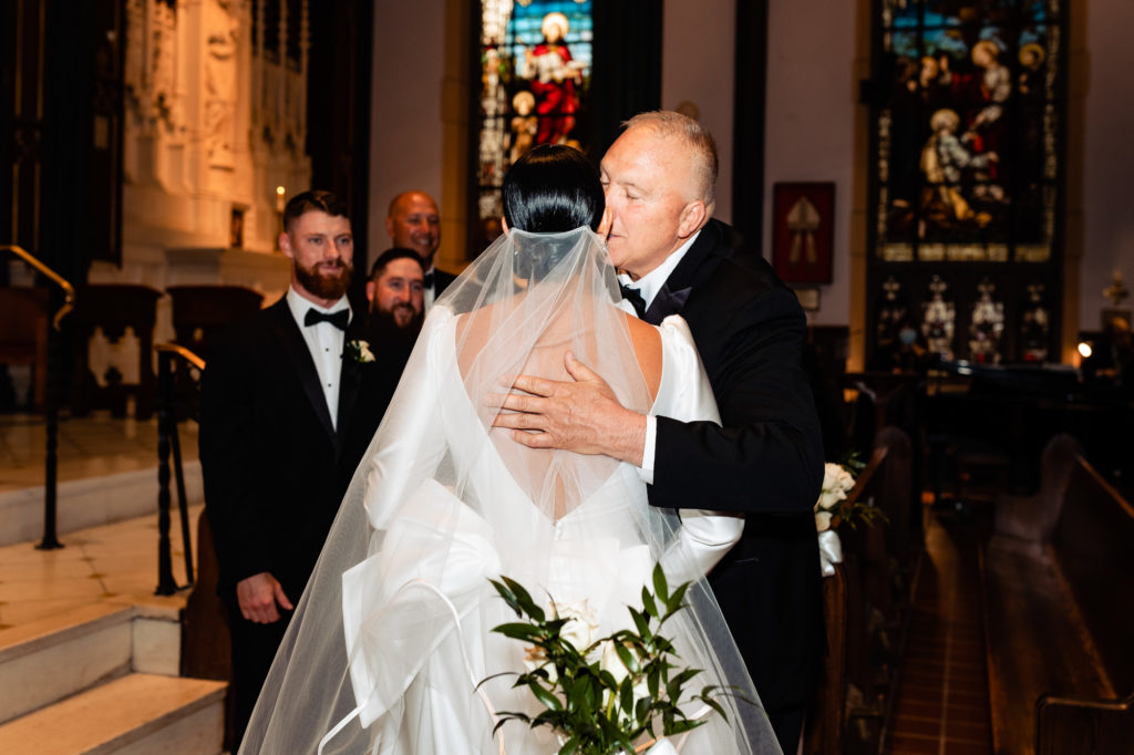 bride's father embraces her