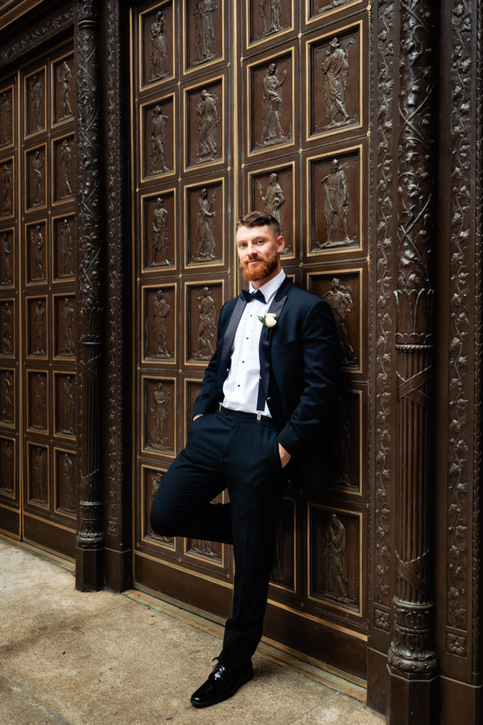 groom solo shot in front of the church