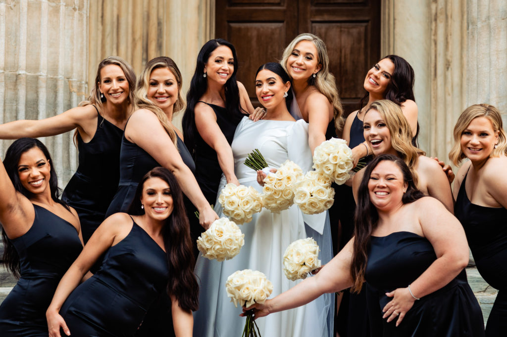 bride and bridesmaids poses for the camera
