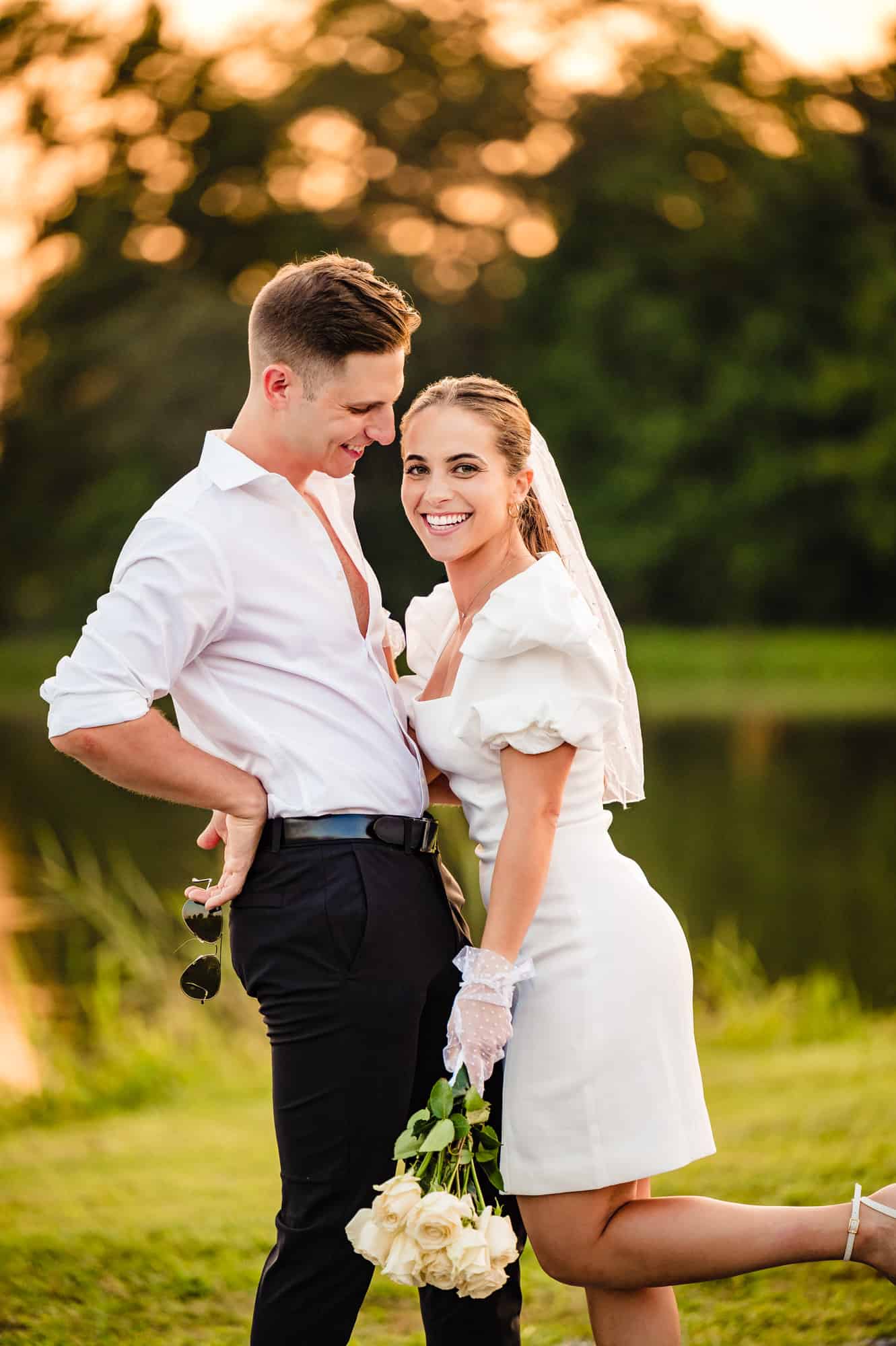 couple are all smiles in front of the camera during their autum lake winery e-shoot