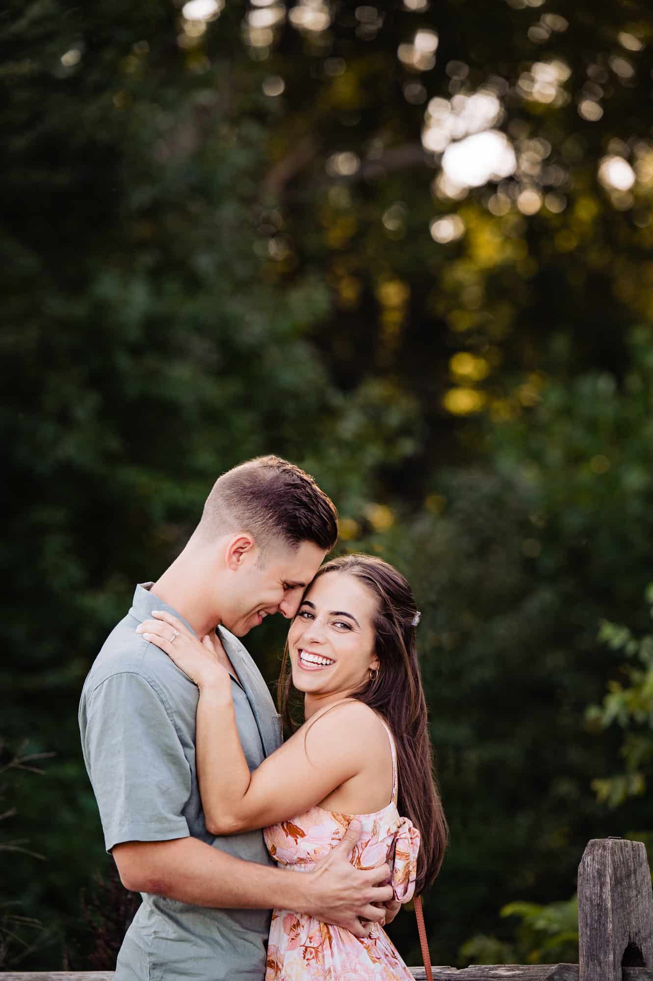 newly engaged couple having a light moment before the camera