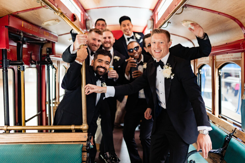 groom and groomsmen posing inside the bus