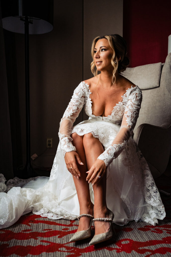 bride sitting on a chair in her wedding gown and wedding heels