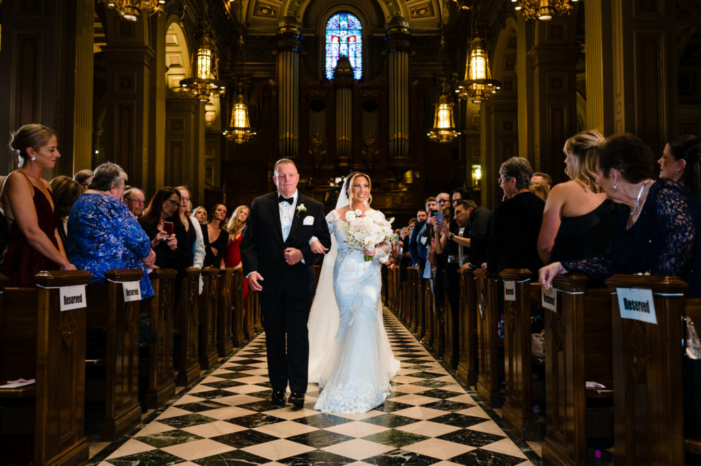 the bride with her father walking on the aisle