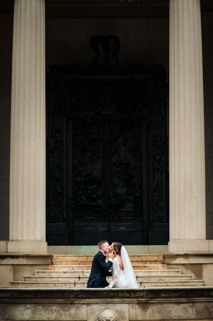 couple kissing in front of the entrance