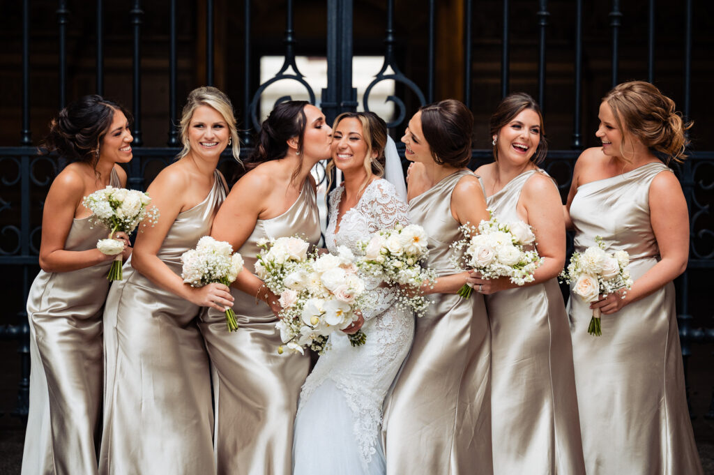 bride and bridesmaids posing for the camera