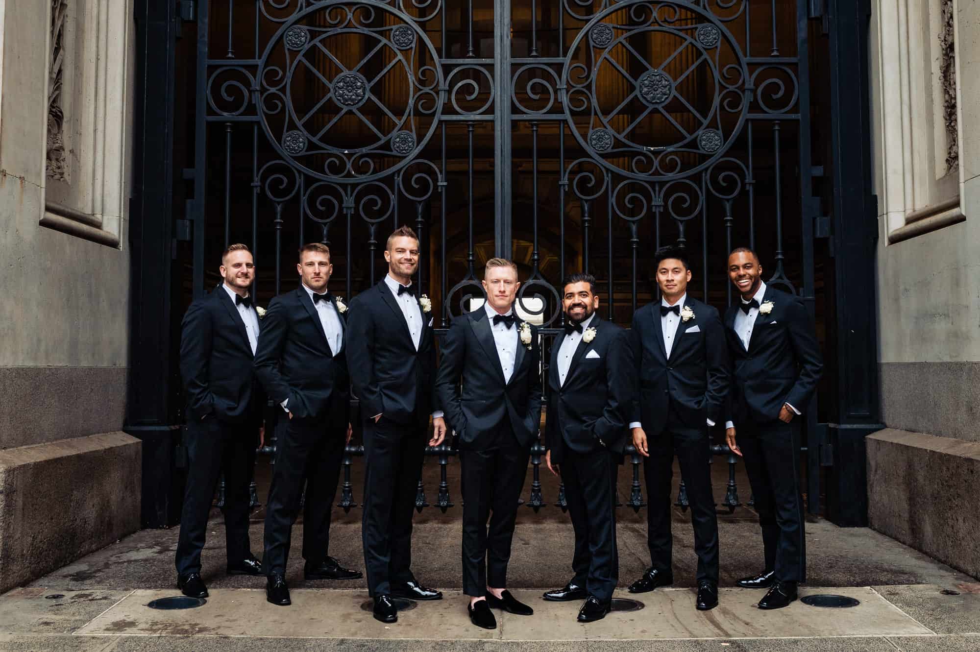 groom and groomsmen posing for the camera