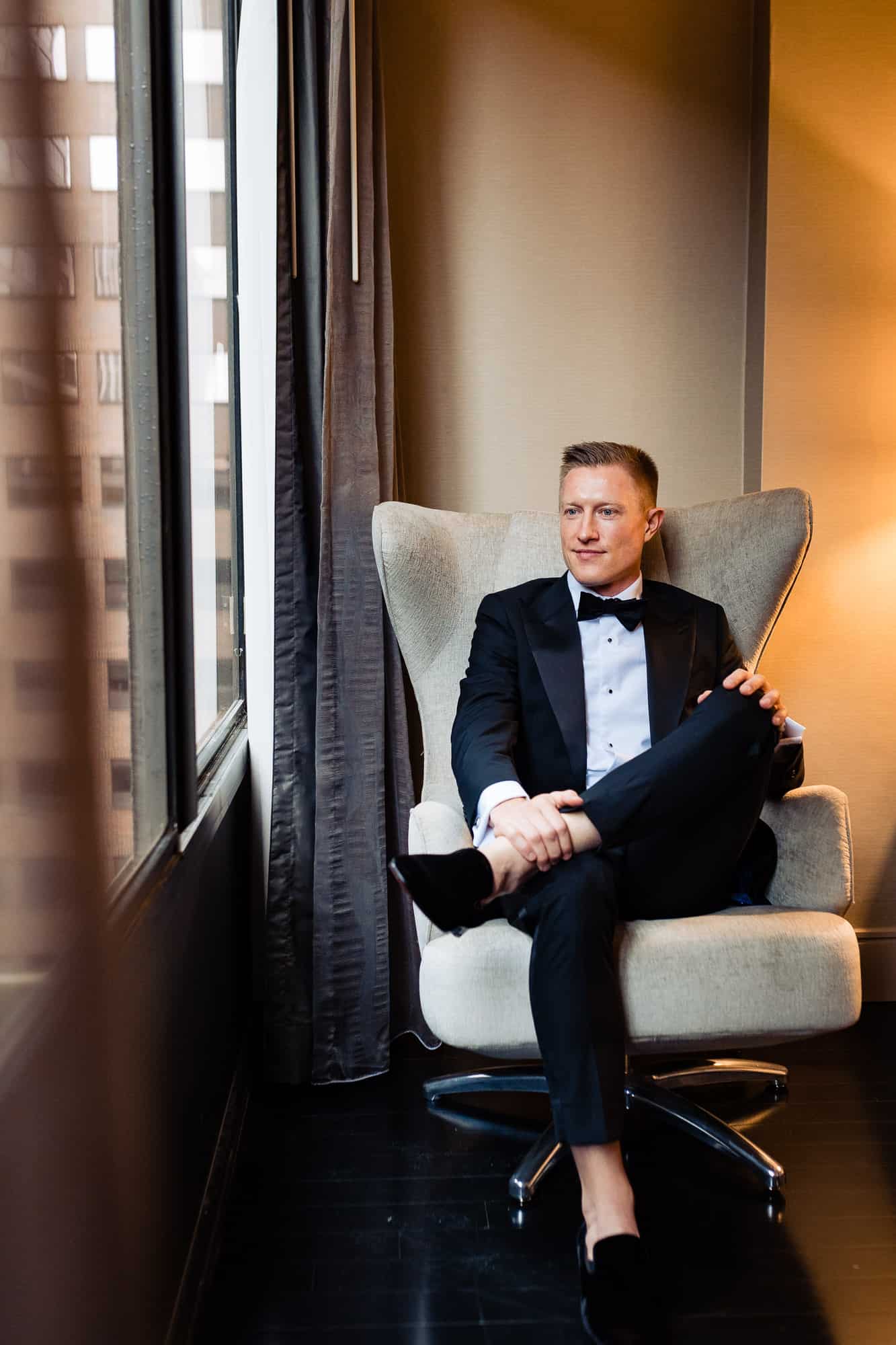 groom posing on the chair