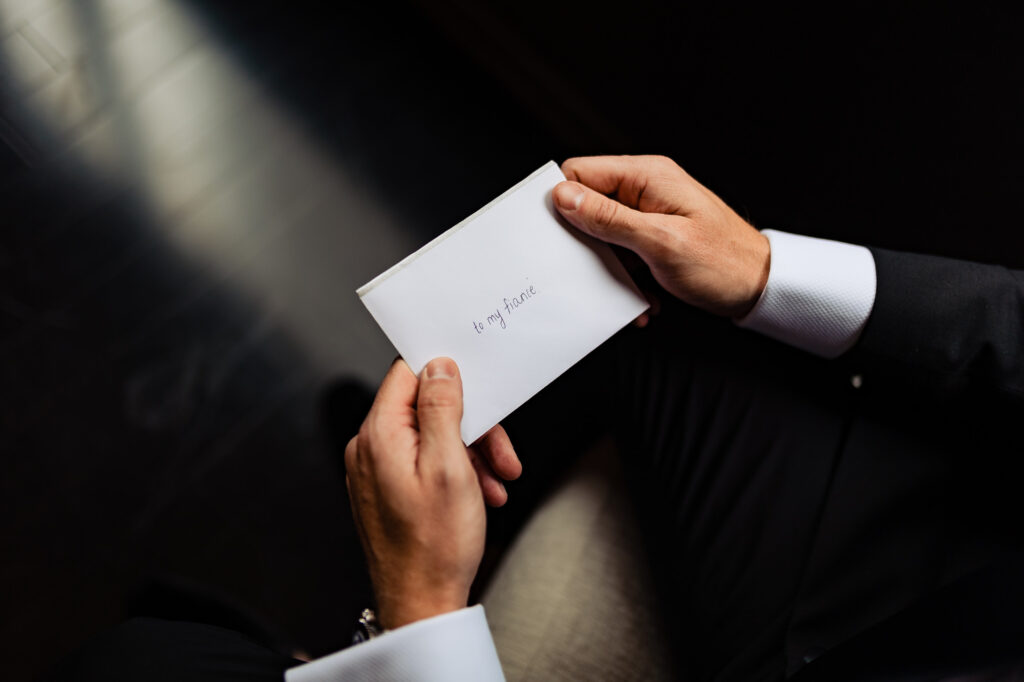 groom reading the bride's wedding letter
