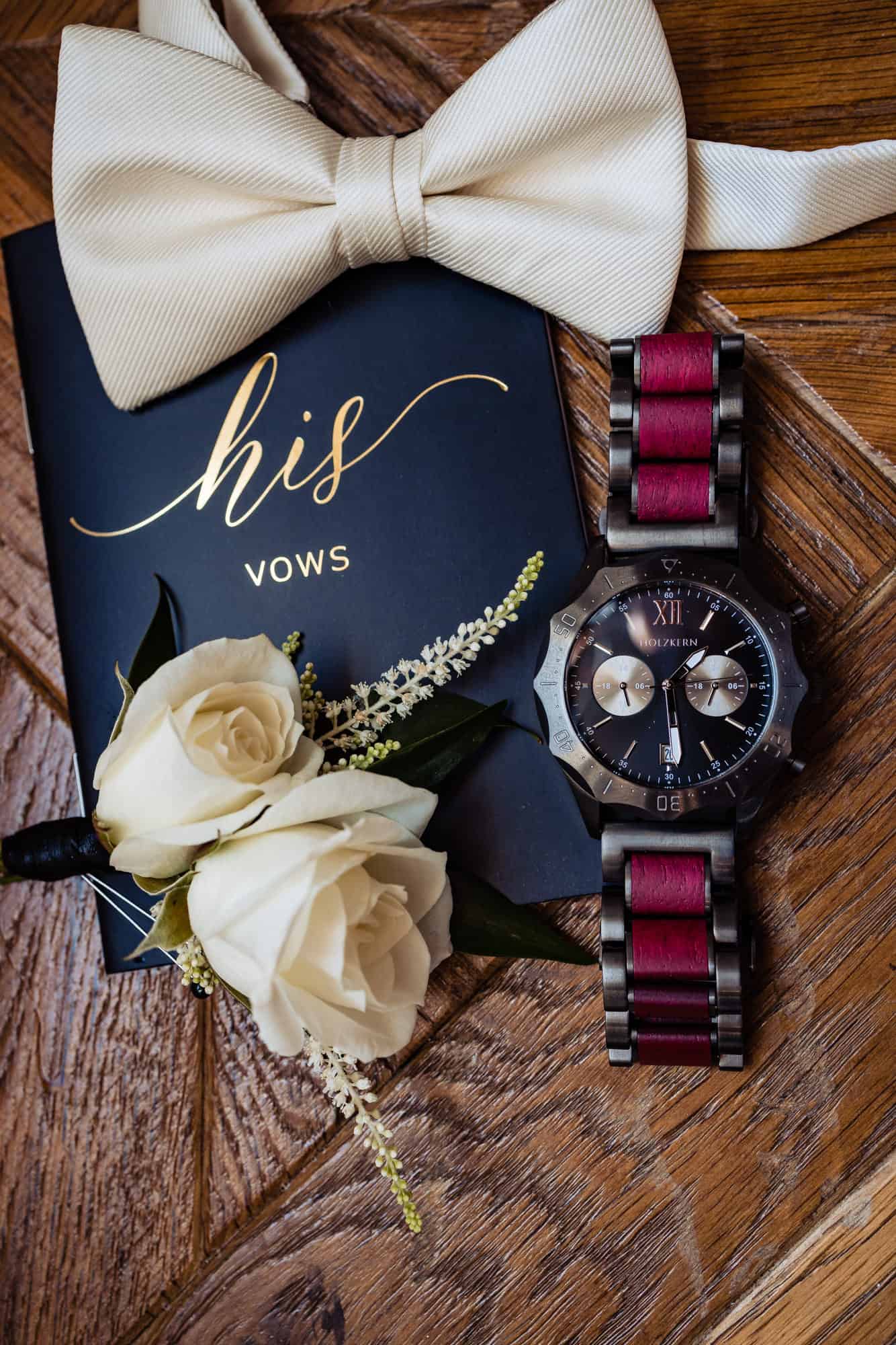 grooms vows,watch and bowtie which are part of the wedding detail photos