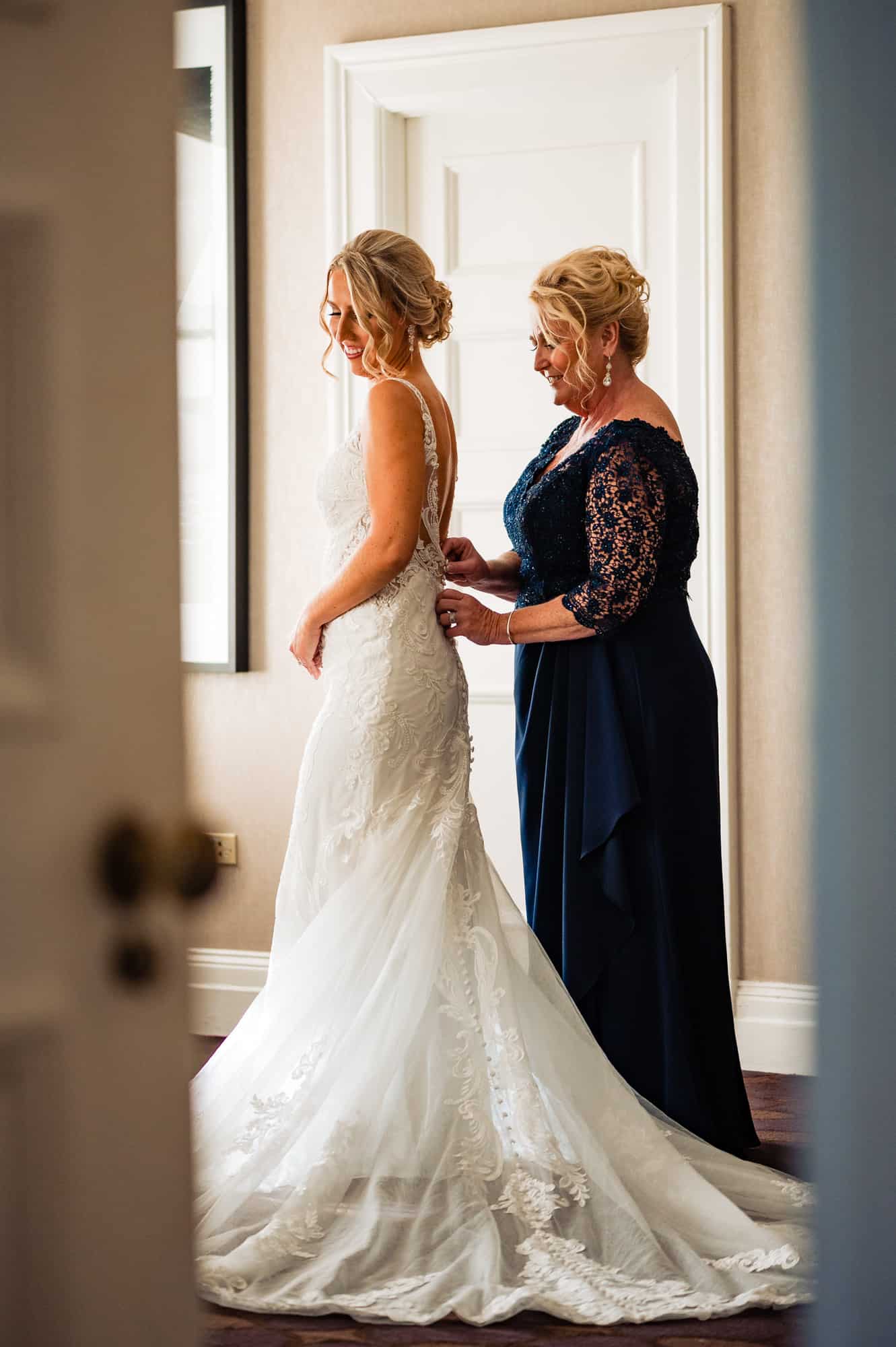 bride's mother fixing her dress