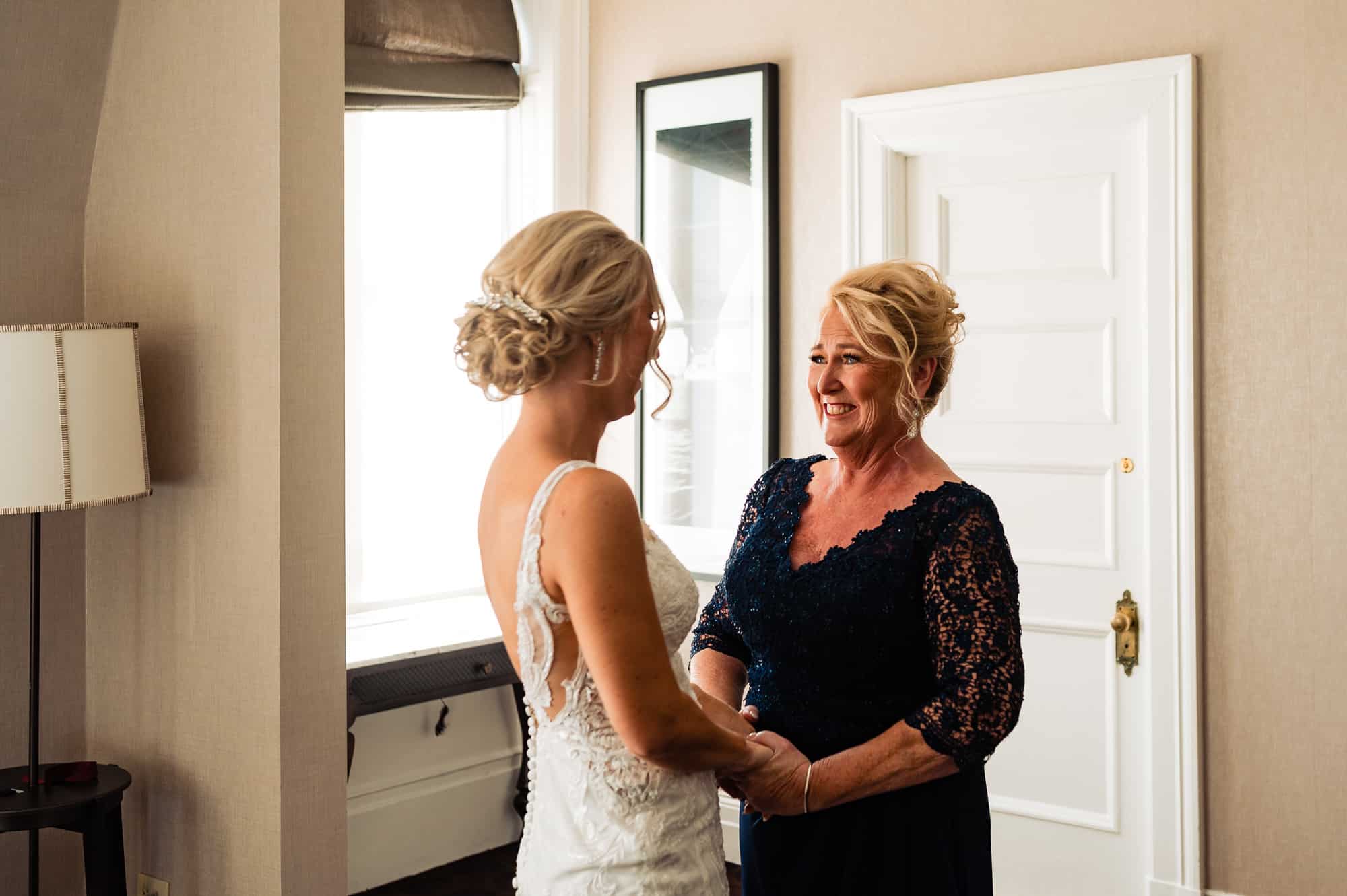 bride and her mother holding hands