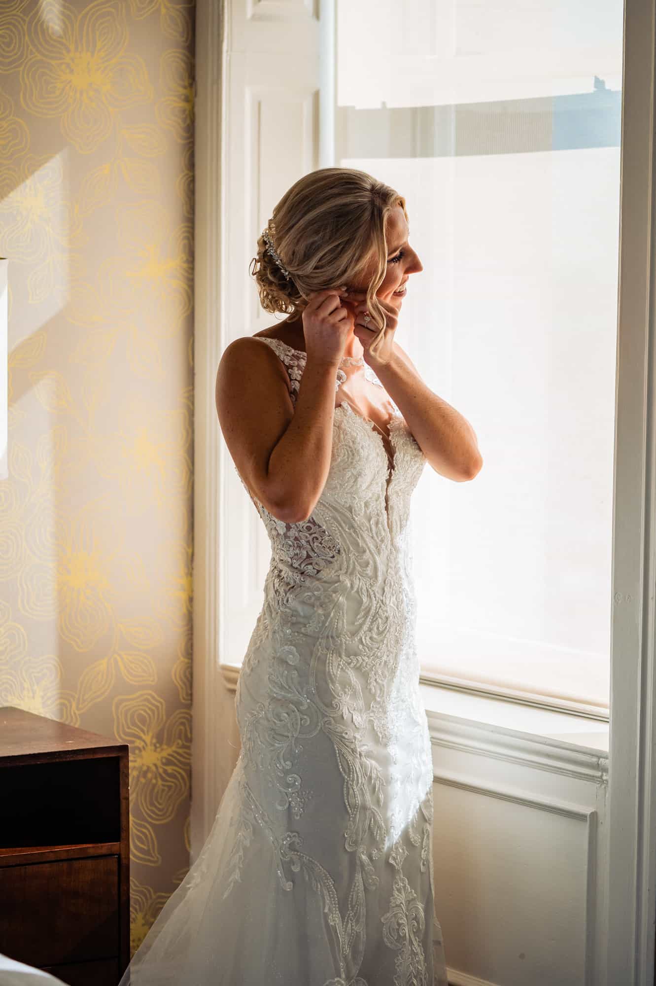 bride putting on her earings