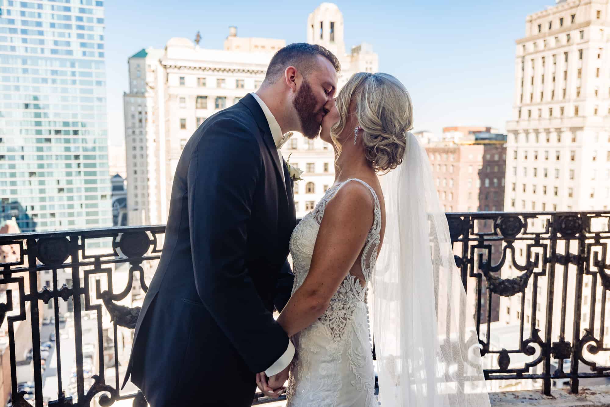 groom kissing bride on the balcony