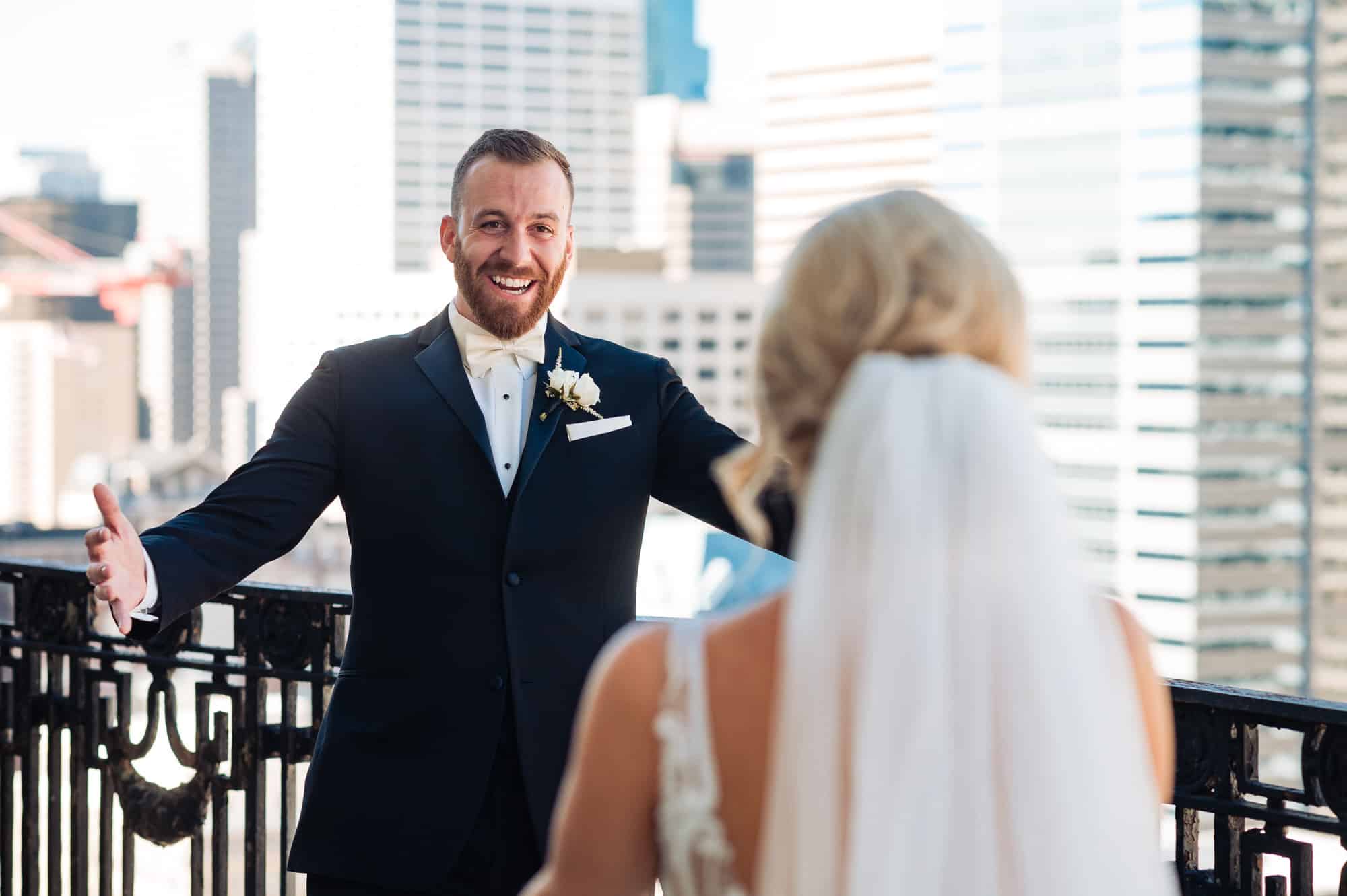 groom leans for a hug to his bride