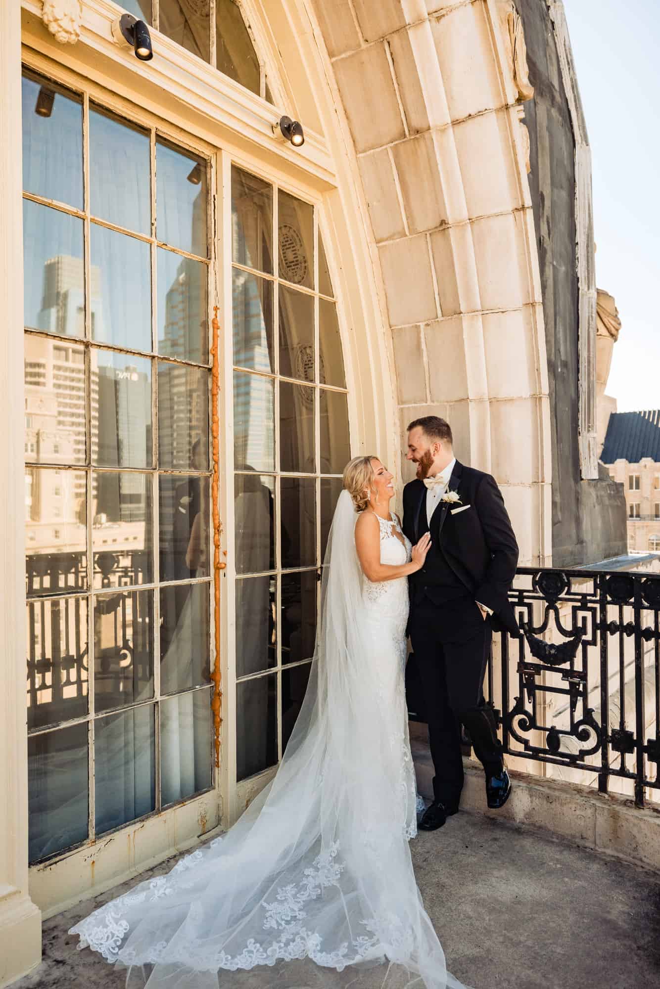 groom and bride smiling at each other