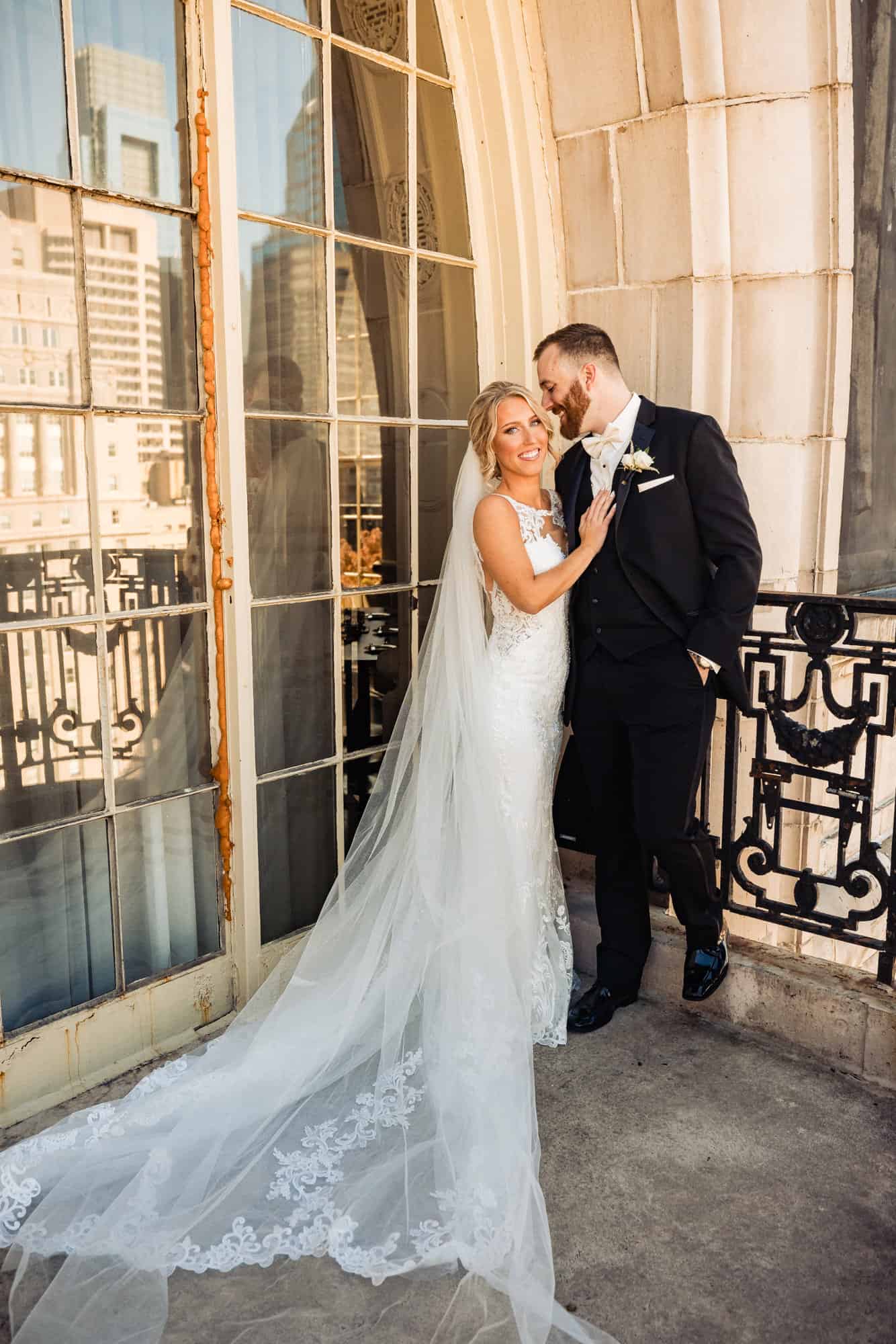 groom and bride smiling at each other