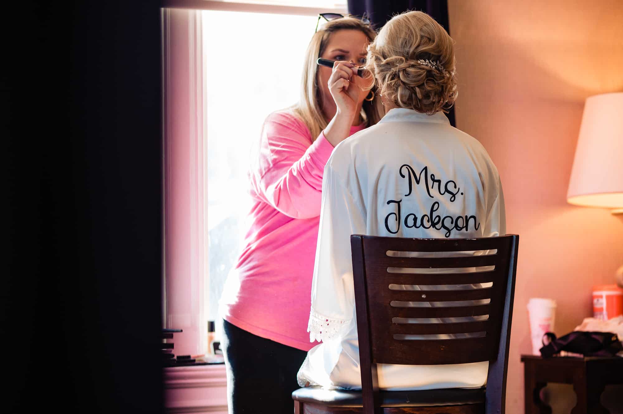 bride getting her makeup done