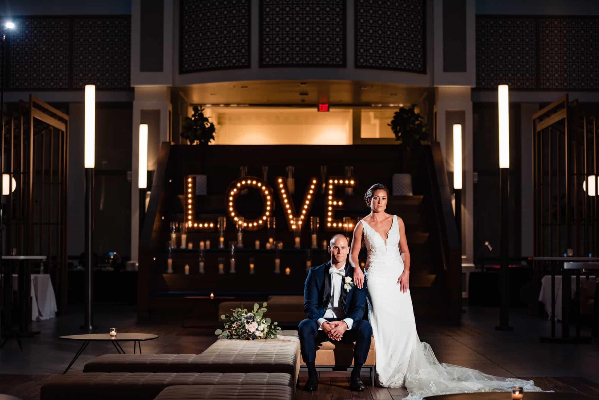 newlyweds posing inside their crystal tea room wedding reception