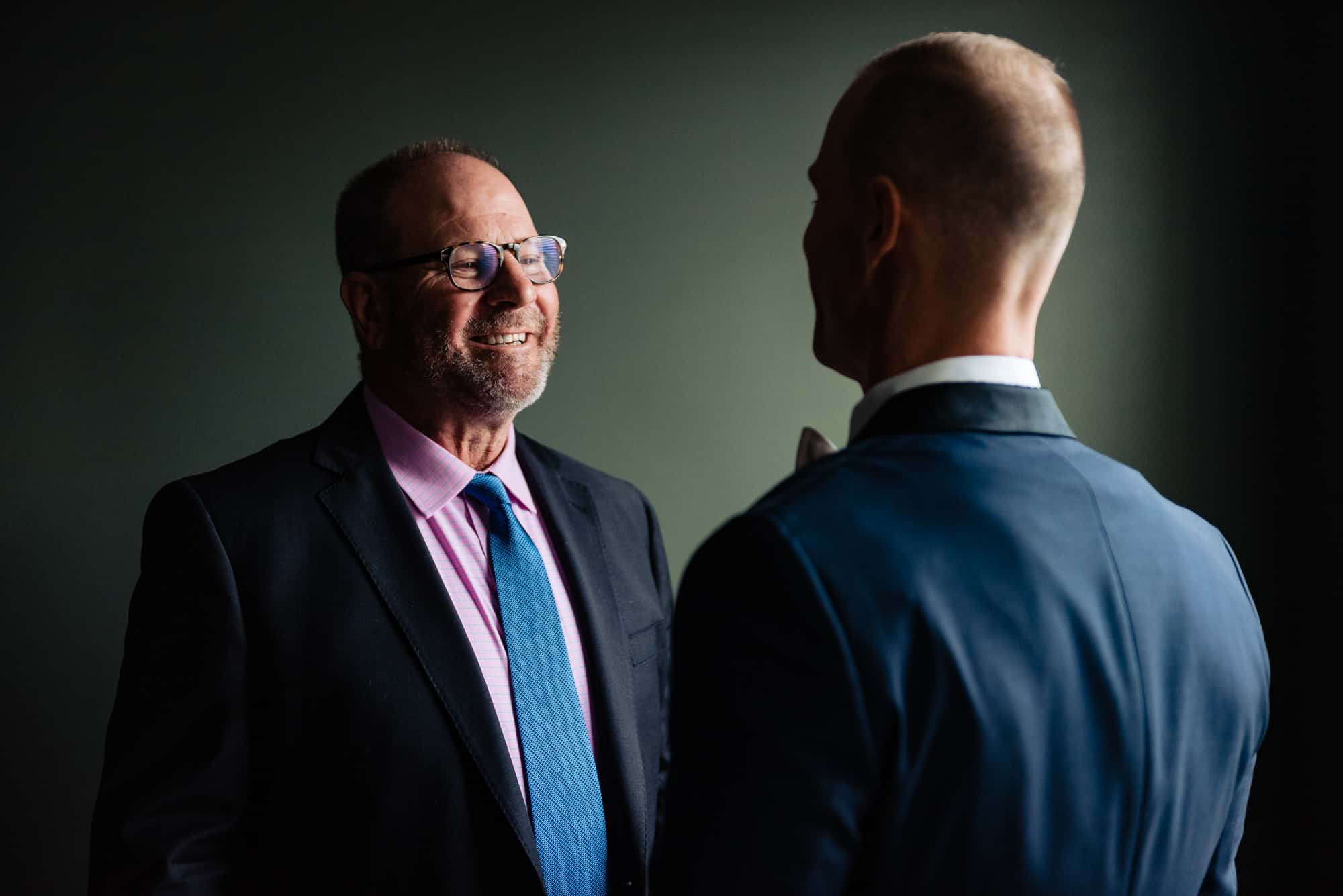 groom with his father smiling at each other