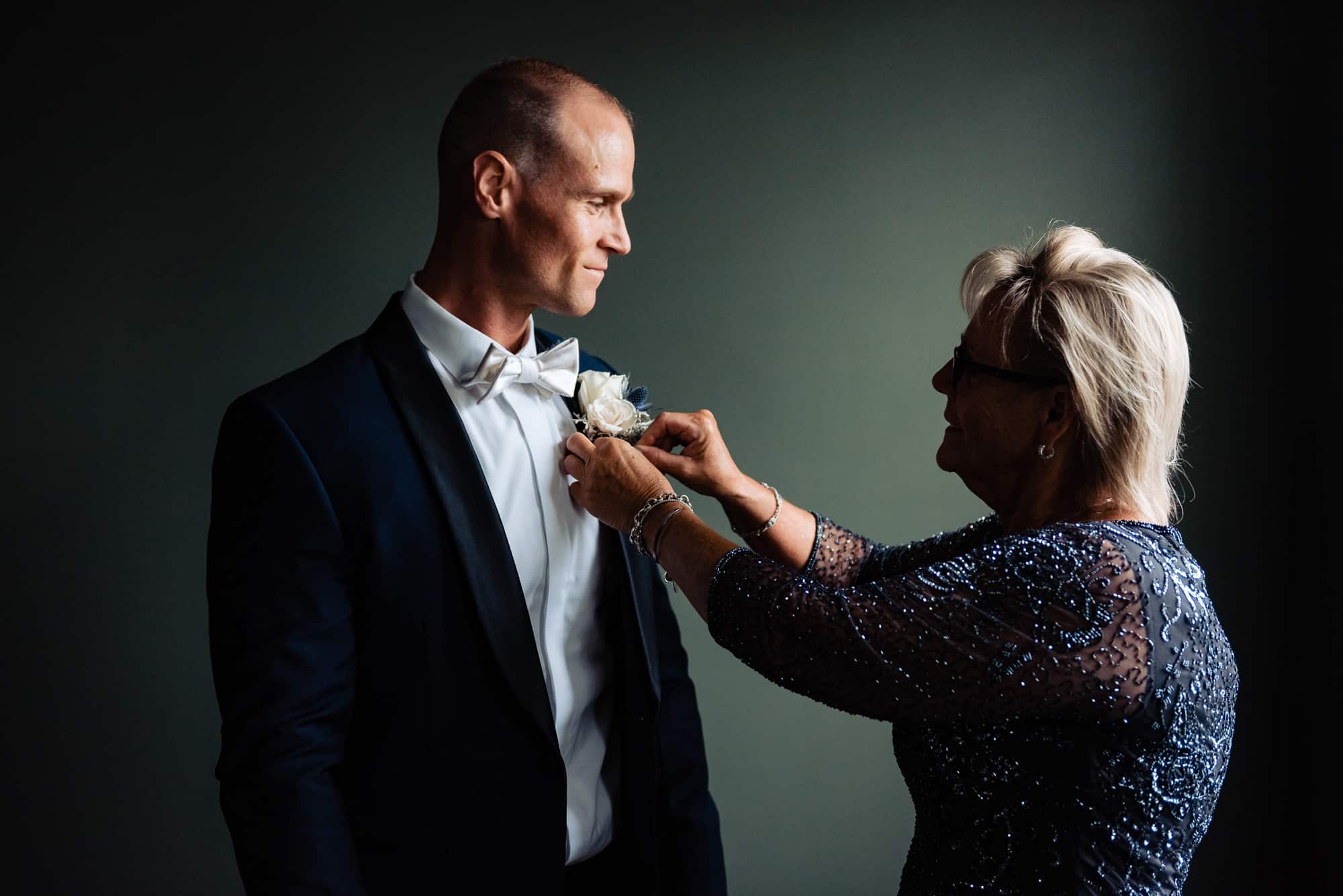 groom's mother fixing his tie