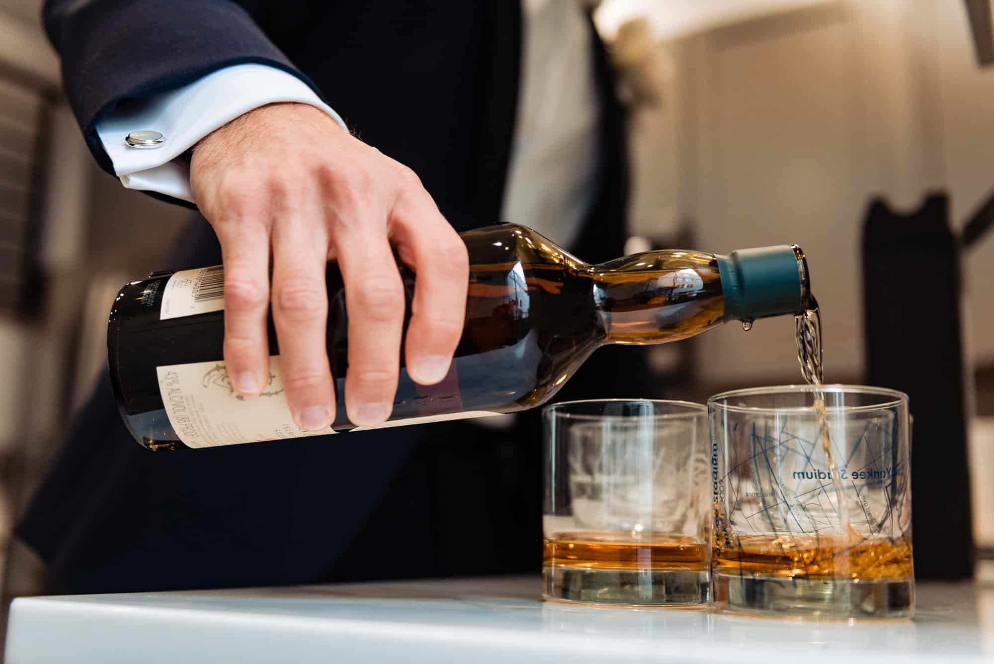 groom pouring a drink