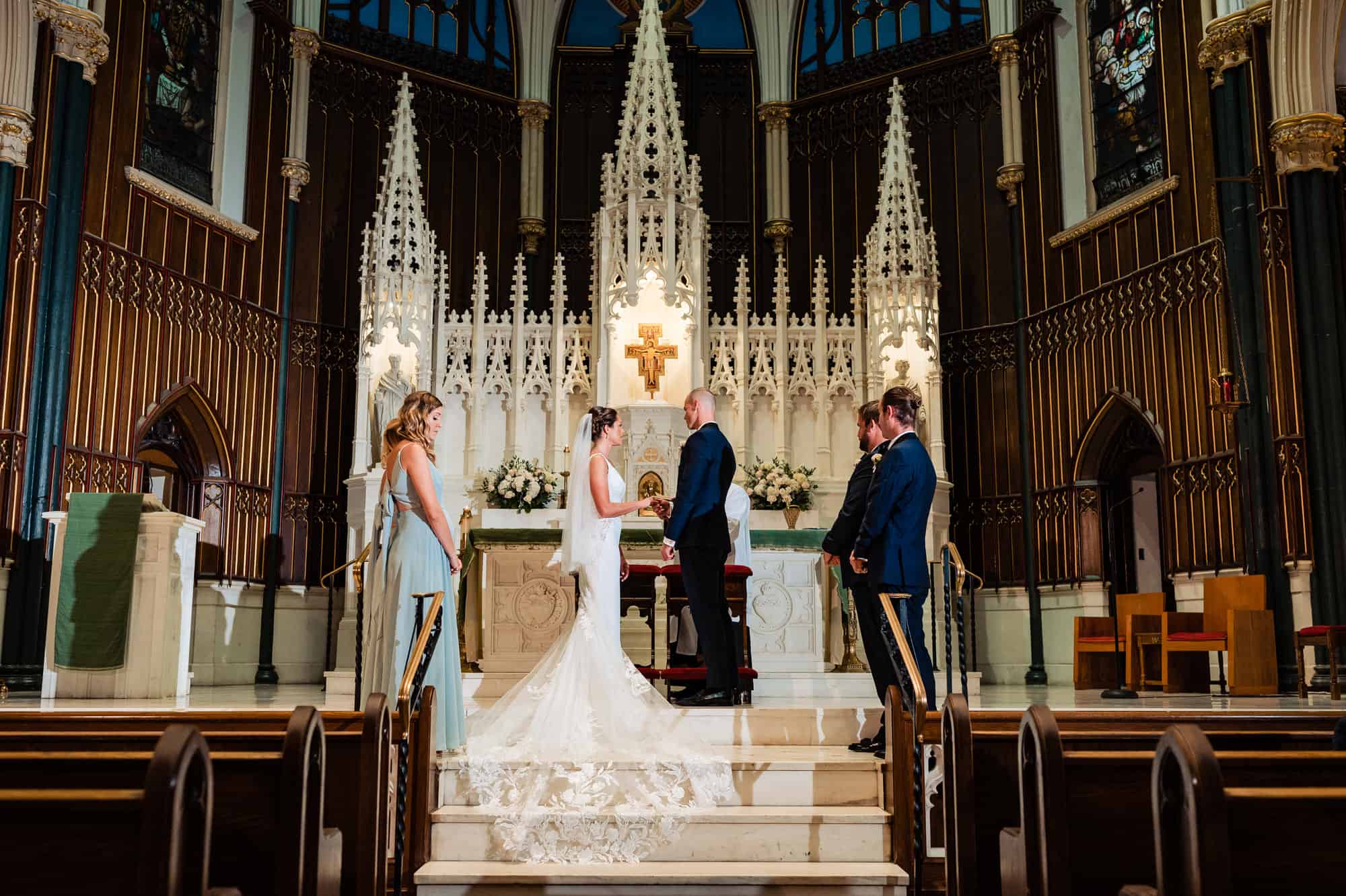 bride and groom at the altar with the bridesmaids and groomsmen