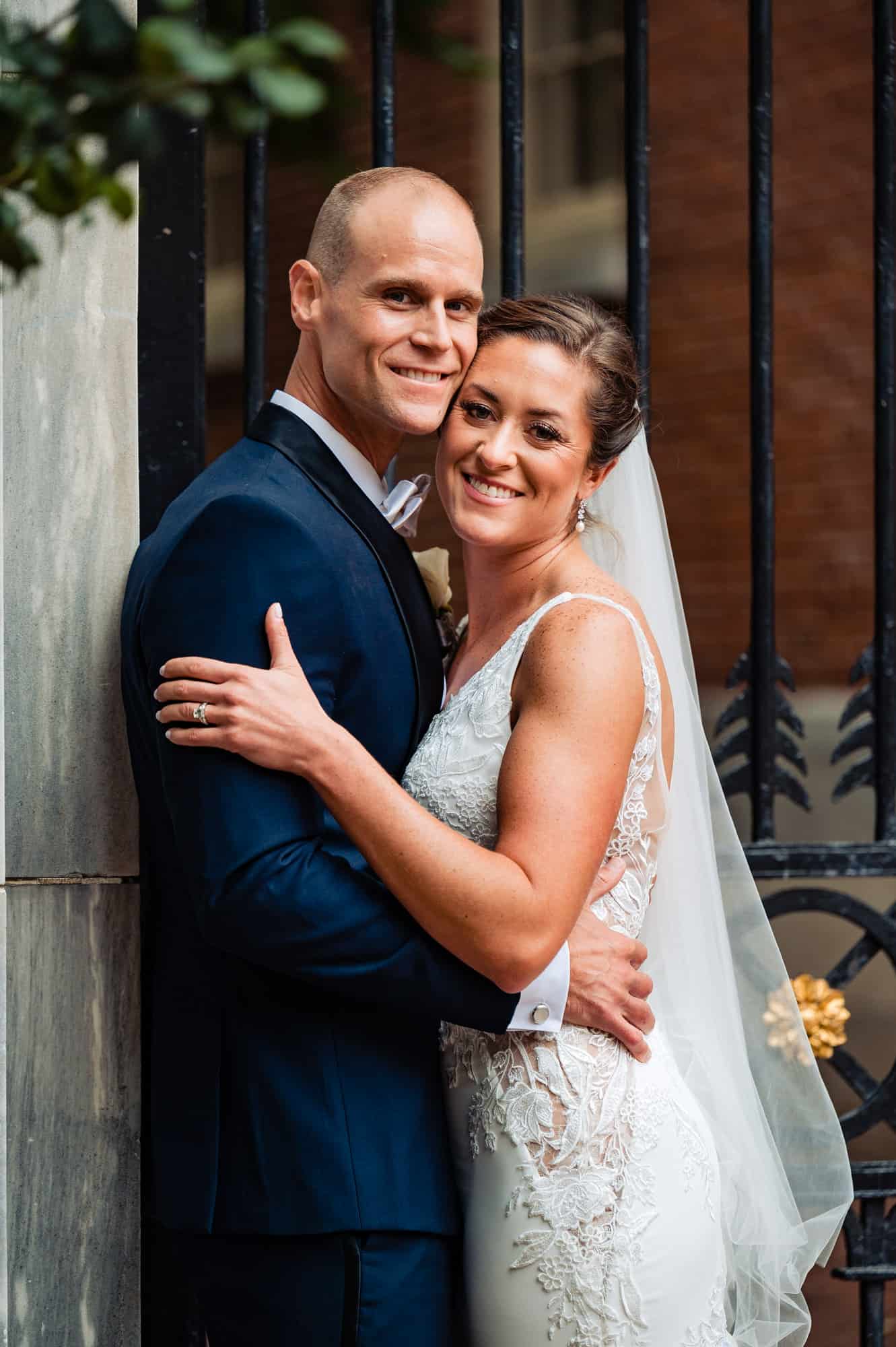 bride and groom hugging and smiling at the camera