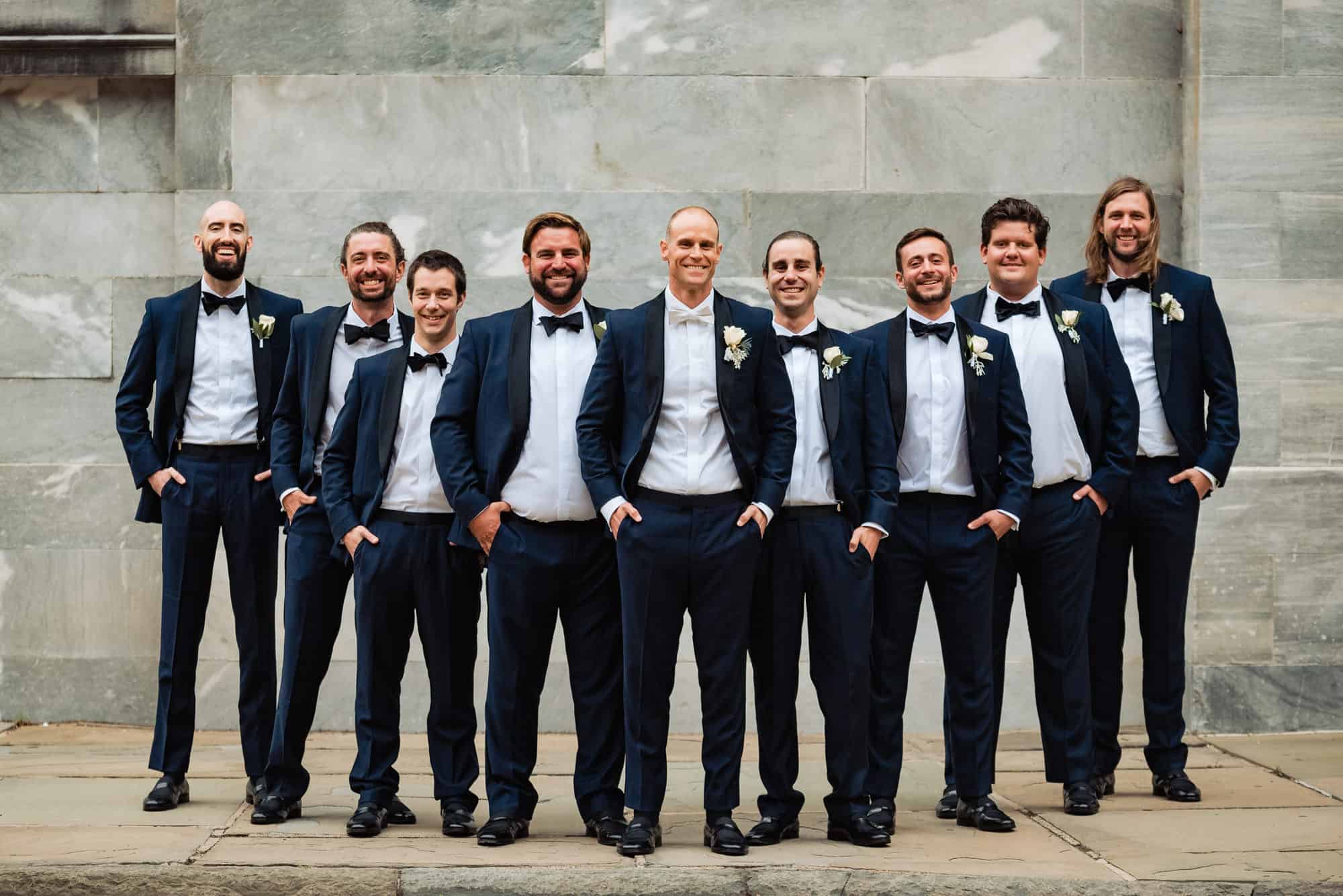 groom and groomsmen posing for the camera