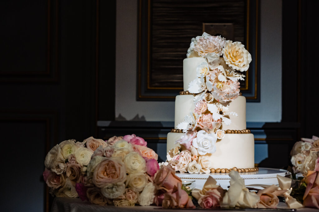 three tiered white and gold wedding cake