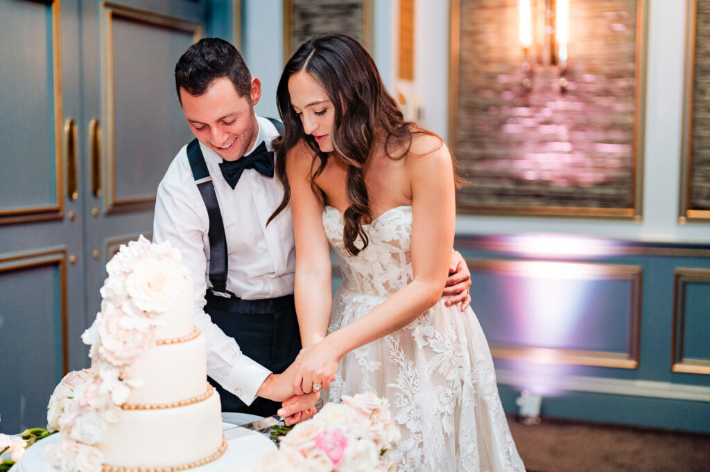the newlyweds cutting their cake