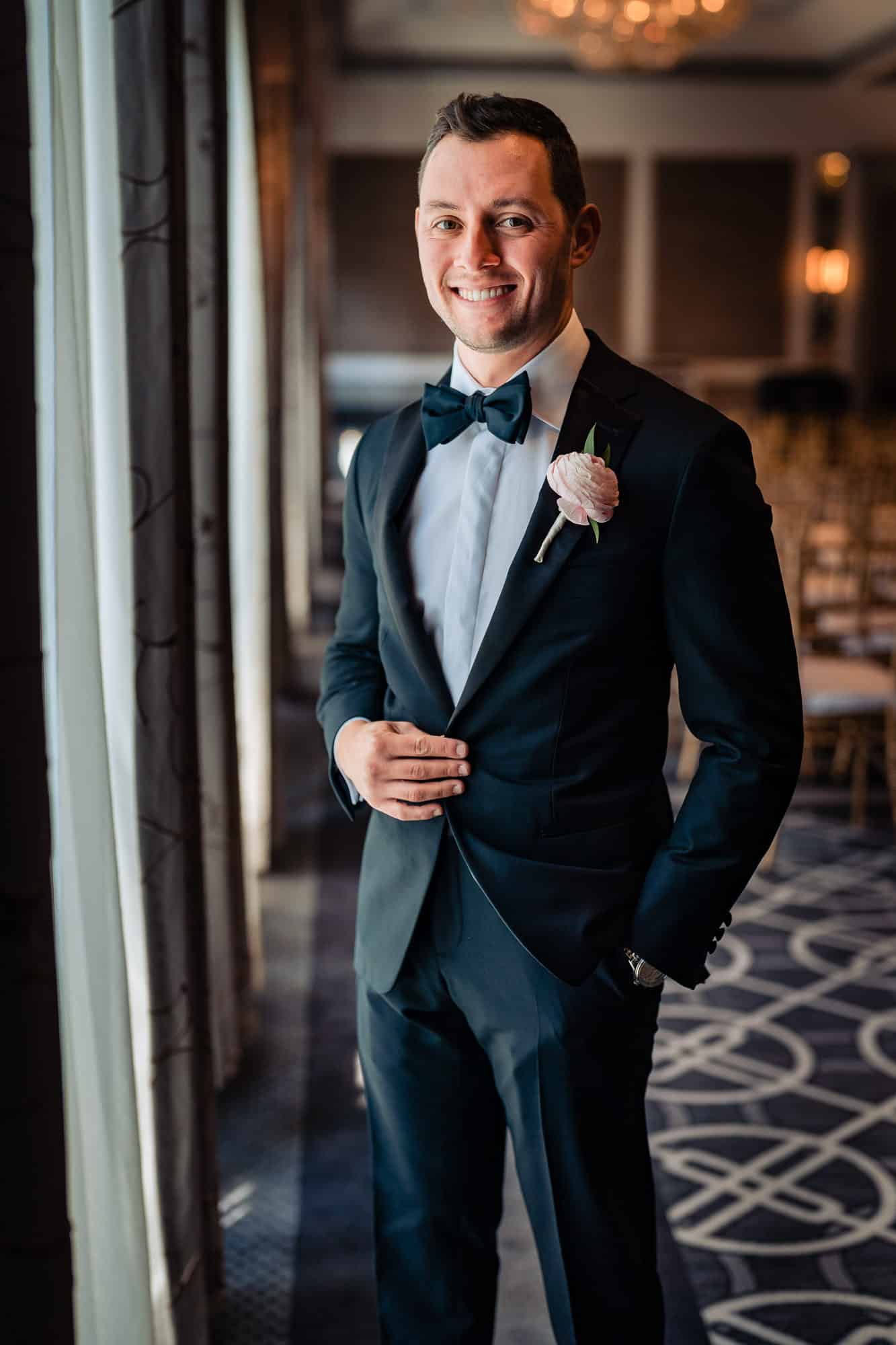 groom smiling inf front of the camera