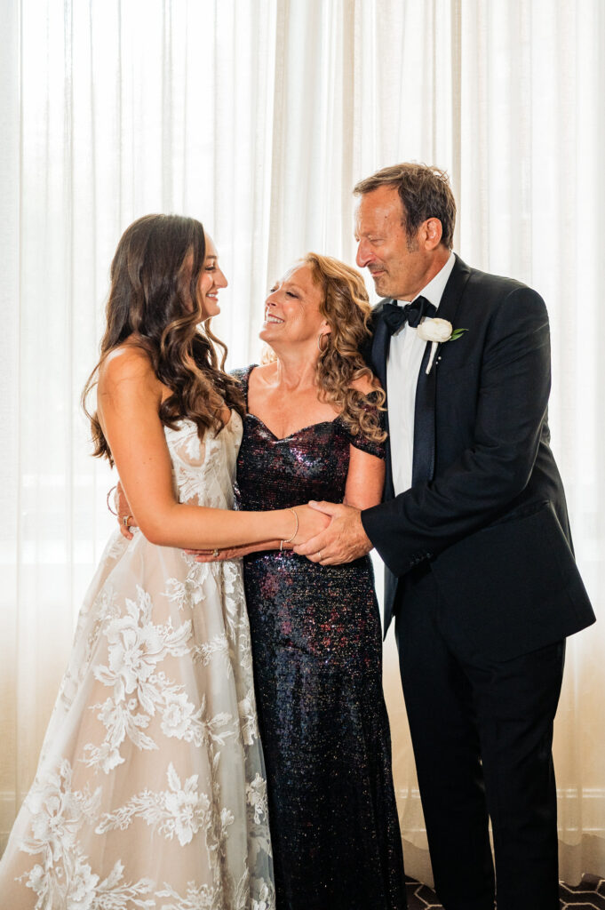 bride hugging her parents before her rittenhouse hotel wedding