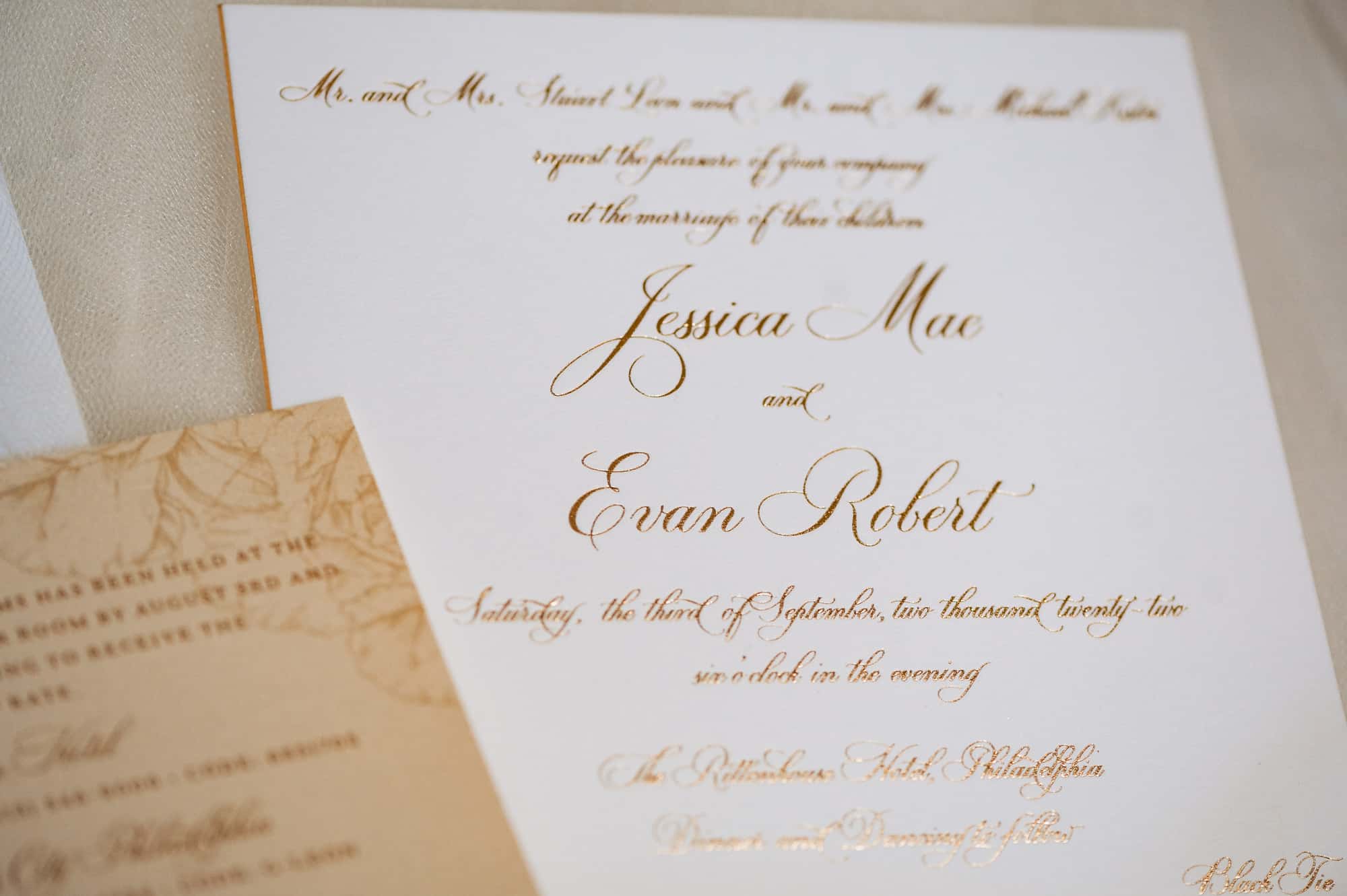 a wedding invitation in gold text